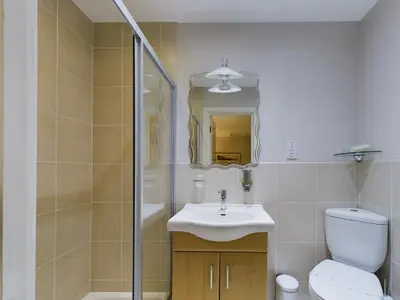 a bathroom with a toilet and a sink and a shower at The Beach House, Luxury Apartments in Blackpool