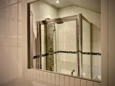 a bathroom with a mirror and a sink at Captivating 4-Bed Hot Tub House in Blackpool in Blackpool