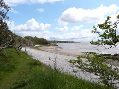 a view of a sandy beach with the ocean at Oak in Ulverston