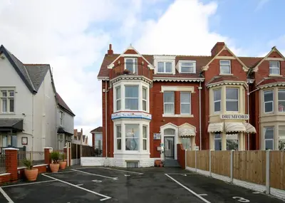 a house with a parking lot in front of it at Pearl Suite in Blackpool