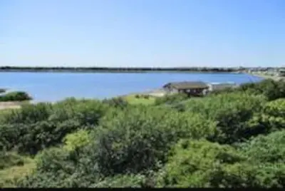 a large body of water with a building in the distance at Beauview Brand New For 2023 Wi-Fi and Smart TV in Millom
