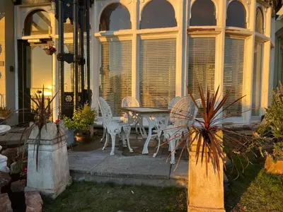a patio with a table and chairs on a house at Ismay Billiard Room Apartment - Titanic Interest in Crosby