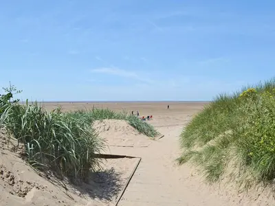 a group of people walking on a sandy beach at One - Uk43696 in Saint Annes on the Sea