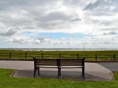 a park bench sitting on the side of a road at Two - Uk43700 in Saint Annes on the Sea